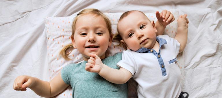 A little girl and her baby brother
