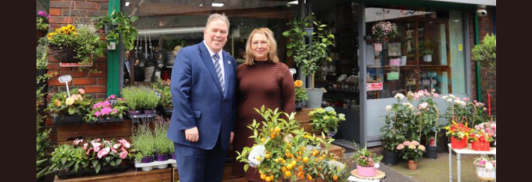 Mayor Perry outside of flower shop