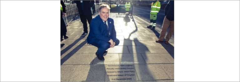 Mayor Perry kneeling at Wellesley Road crossing