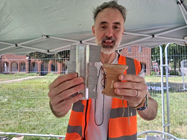 A man holding a find at a community archaeology project at Ashburton Park in May 2026