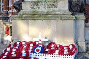 poppy wreaths placed at the foot of the cenotaph in Katharine Street, Croydon