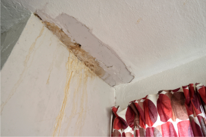 Stock photo of water damage on a ceiling and wall
