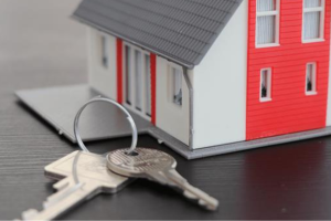A close up of a model house with keys next to it