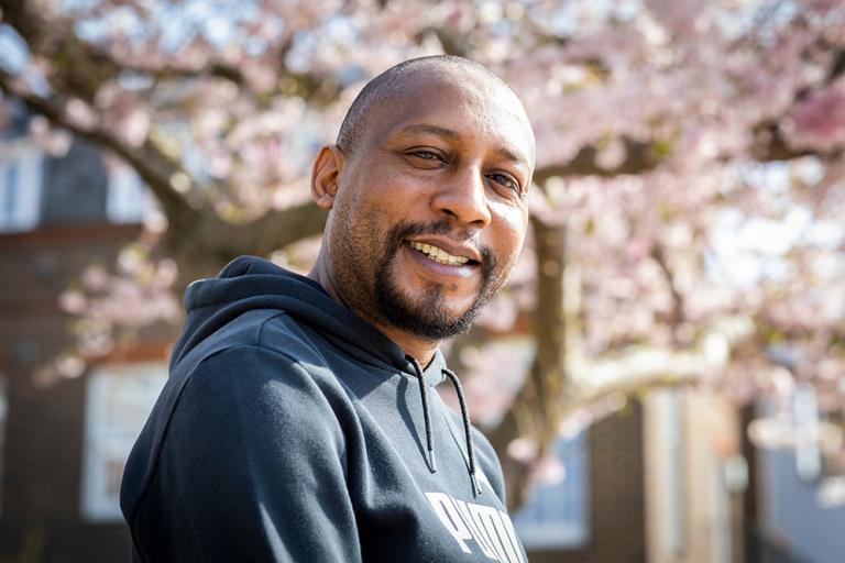 Smiling man with blossom tree in the background