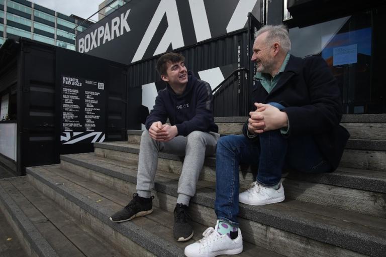 Two males chatting on some steps