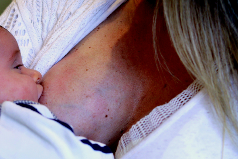 A baby breastfeeding.