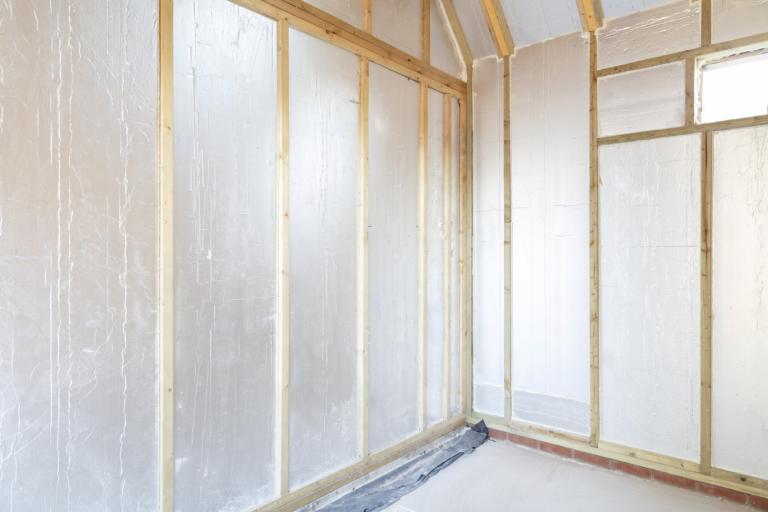 Modern timber house construction with rigid insulation boards.